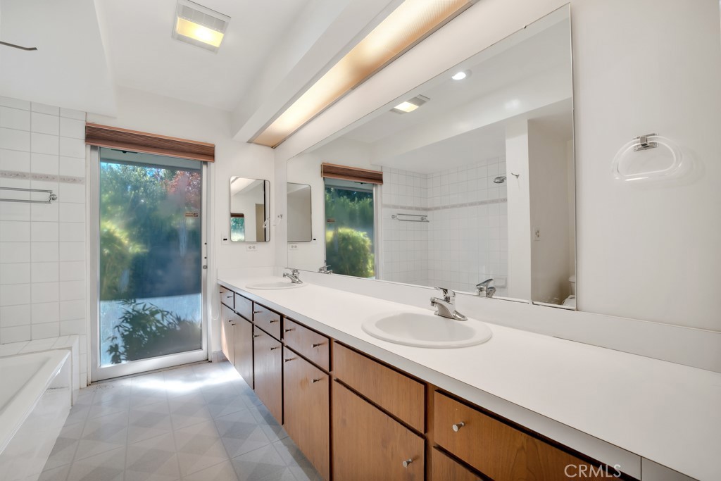 18912 Blackhawk Street Porter Ranch, CA 91326 - Photo 24 of 48 a bathroom with a sink double vanity and a mirror