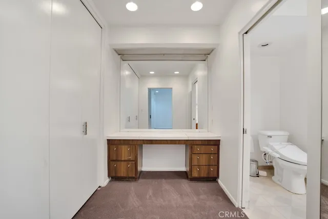 an empty room with windows and chandelier fan