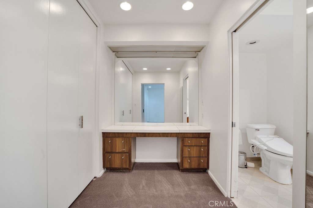 18912 Blackhawk Street Porter Ranch, CA 91326 - Photo 26 of 48 a spacious bathroom with a toilet sink and a mirror