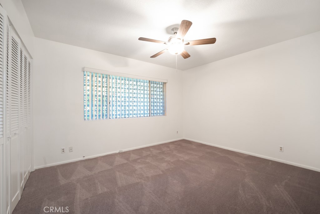 18912 Blackhawk Street Porter Ranch, CA 91326 - Photo 28 of 48 an empty room with windows and chandelier fan
