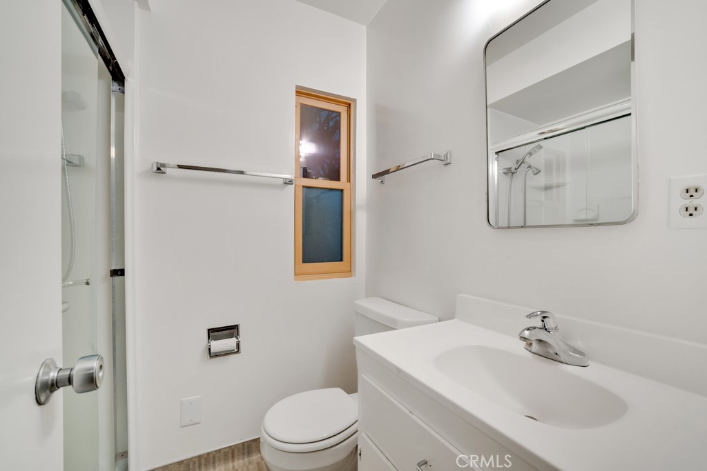 18912 Blackhawk Street Porter Ranch, CA 91326 - Photo 34 of 48 a bathroom with a white toilet sitting next to a bathroom sink