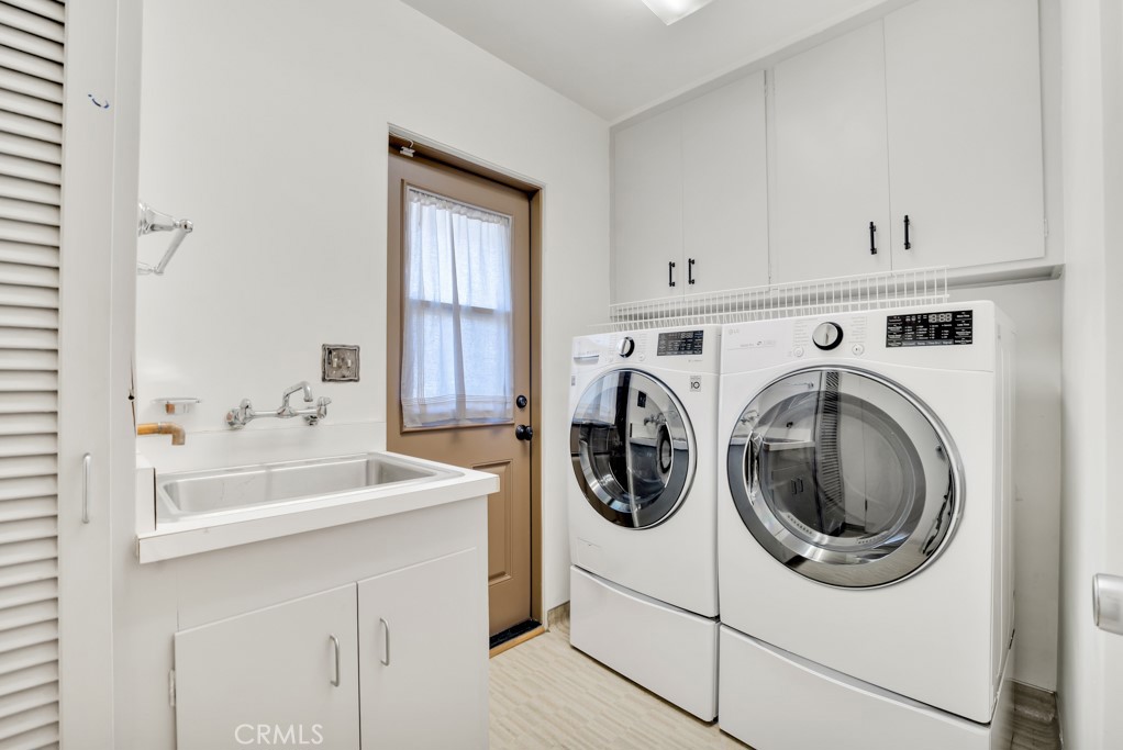 18912 Blackhawk Street Porter Ranch, CA 91326 - Photo 37 of 48 a utility room with sink dryer and washer