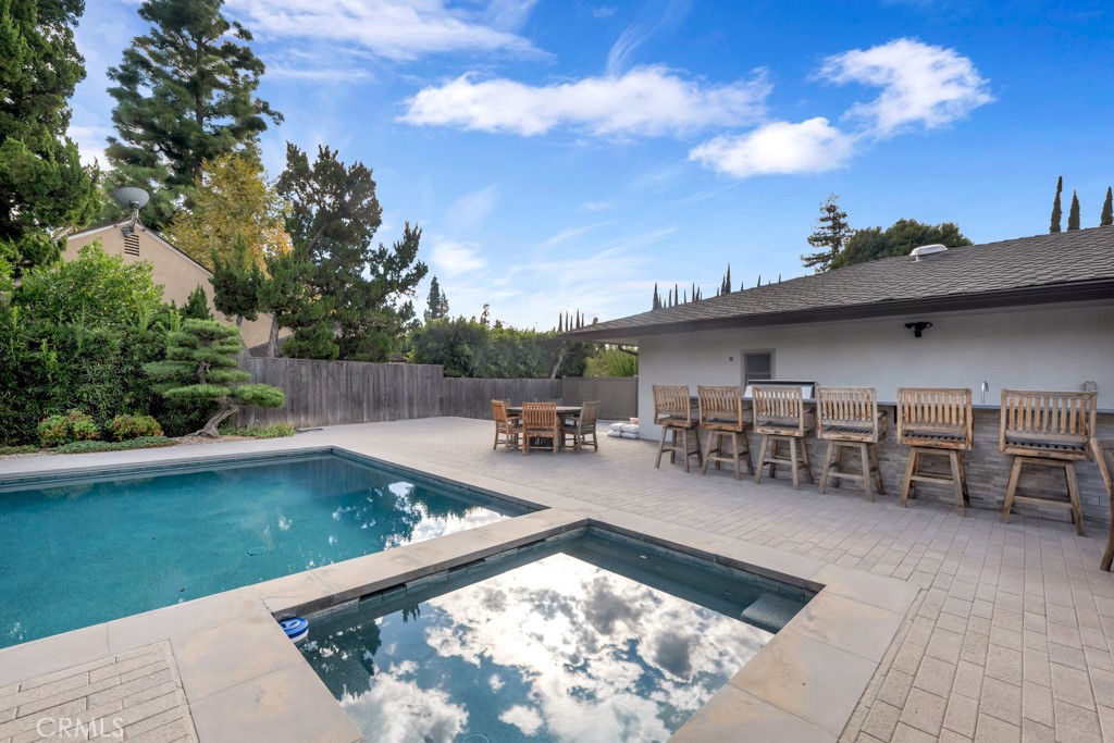 18912 Blackhawk Street Porter Ranch, CA 91326 - Photo 40 of 48 a view of a swimming pool with chairs