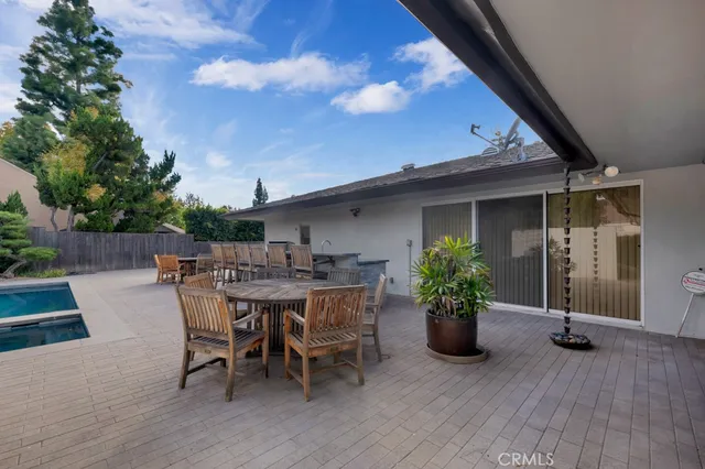 a backyard of a house with an outdoor space and seating area