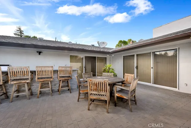 a view of backyard with a table and chairs and a fire pit
