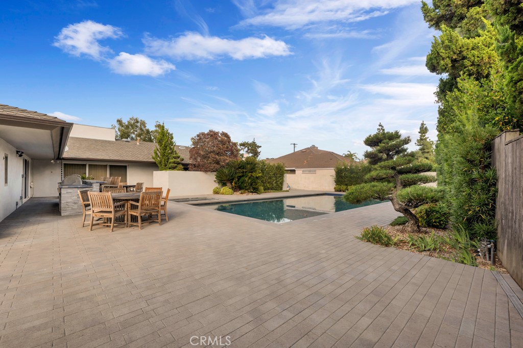 18912 Blackhawk Street Porter Ranch, CA 91326 - Photo 46 of 48 a view of backyard with a table and chairs and a fire pit