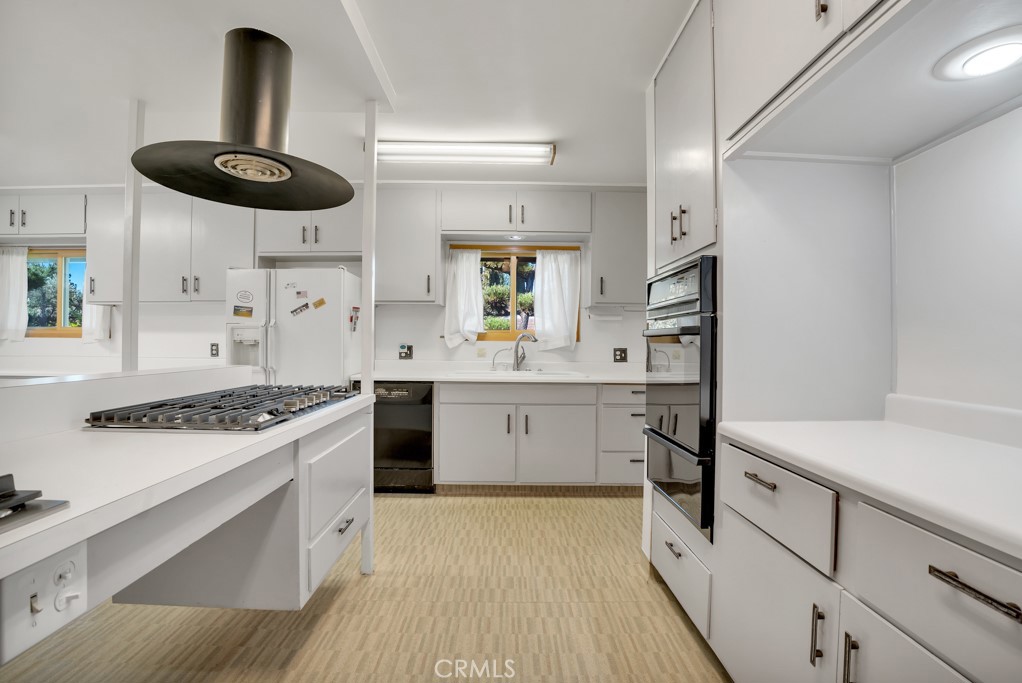 18912 Blackhawk Street Porter Ranch, CA 91326 - Photo 8 of 48 a kitchen with a stove a sink and a refrigerator