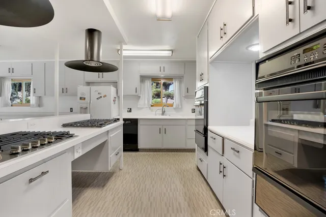 a kitchen with stainless steel appliances a sink and cabinets