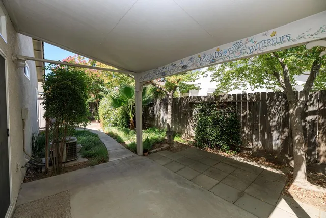 a living room with large windows and a table and chairs