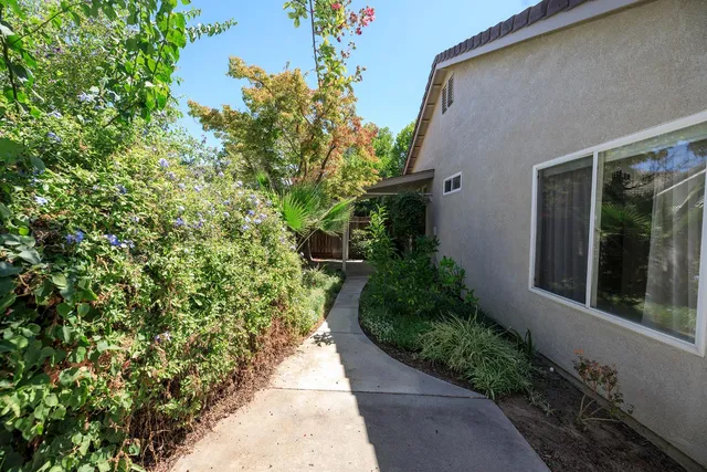 a view of a pathway both side of the house