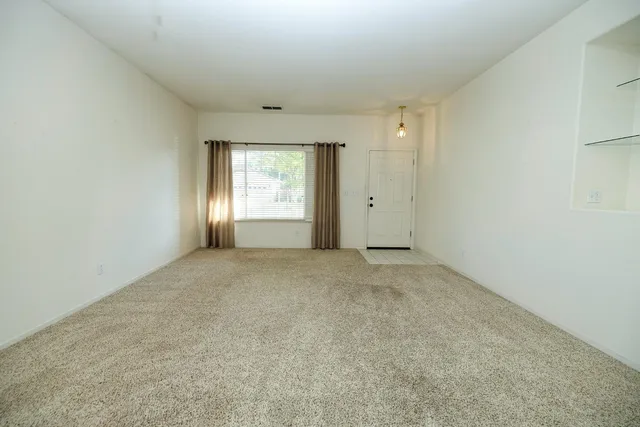 an empty room with windows and closet