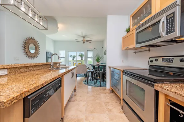 a kitchen with stainless steel appliances granite countertop a stove and a sink