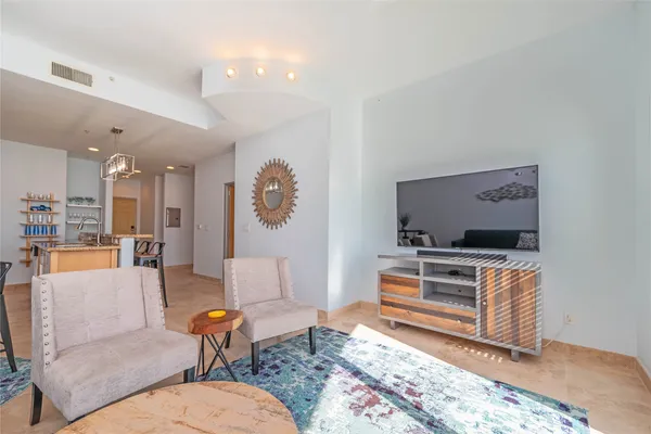 a living room with furniture and a rug