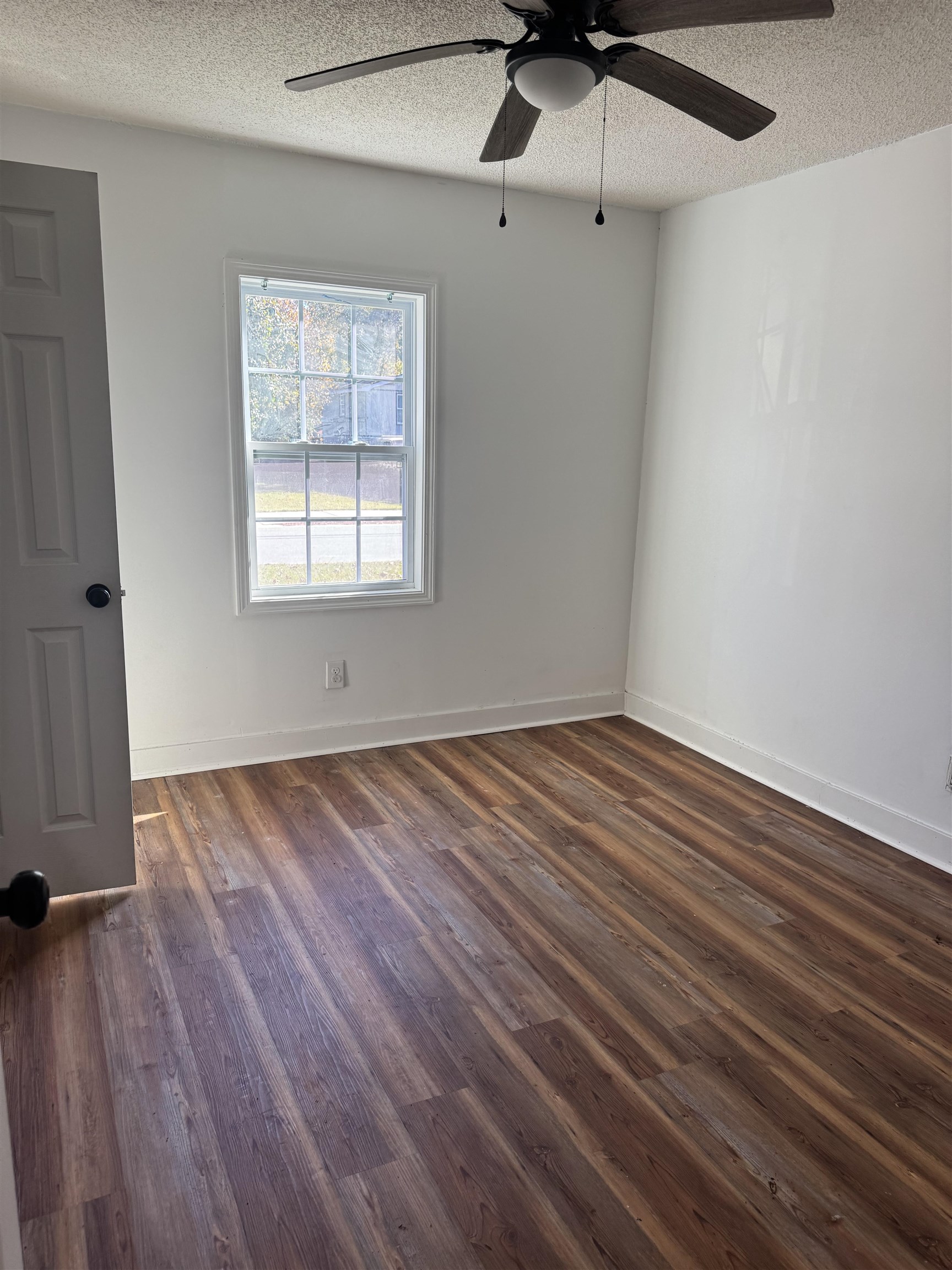 809 North Dargan Street Florence, SC 29506 - Photo 6 of 13 Spare room featuring dark wood-style floors, a textured ceiling, and a ceiling fan