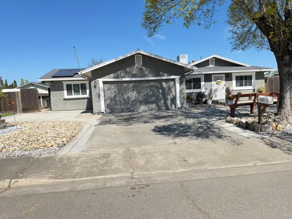 a front view of a house with yard and seating area