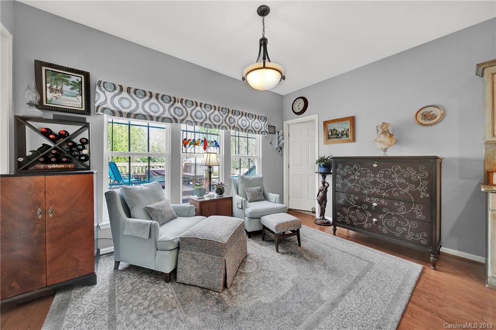 720 Warwick Way Fort Mill, SC 29708 - Photo 13 of 36 a living room with furniture a dining table and a fireplace
