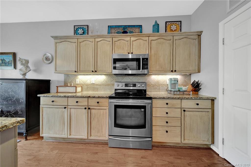 720 Warwick Way Fort Mill, SC 29708 - Photo 14 of 36 a kitchen with stainless steel appliances granite countertop a stove and a microwave