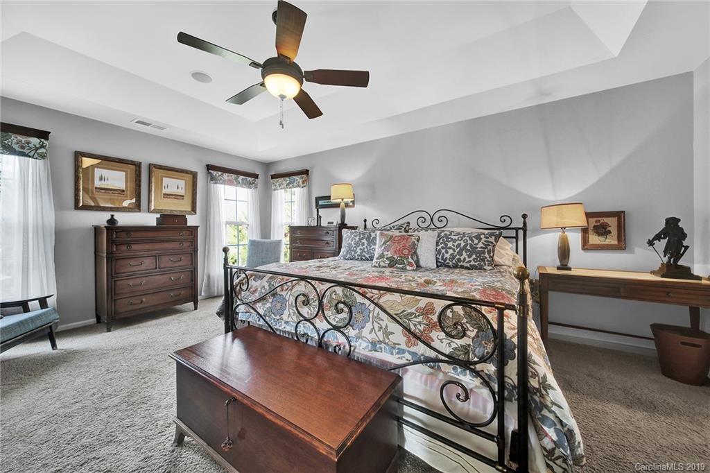 720 Warwick Way Fort Mill, SC 29708 - Photo 16 of 36 a bedroom with a bed and a chandelier