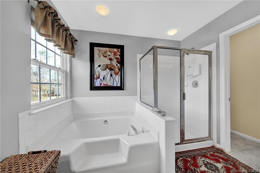 720 Warwick Way Fort Mill, SC 29708 - Photo 17 of 36 a bathroom with a bathtub and a shower