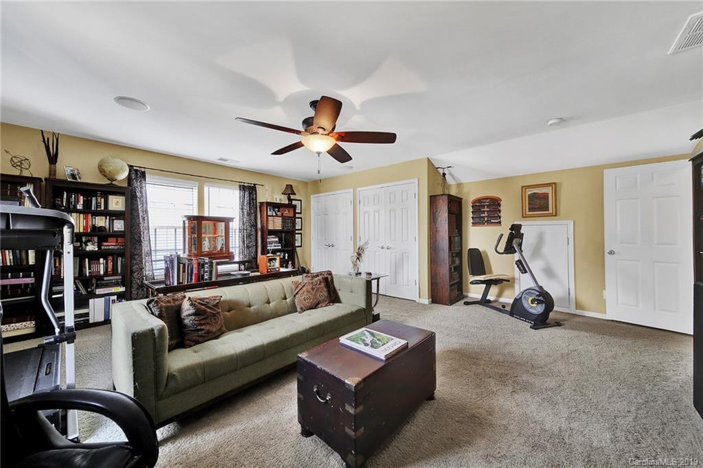 720 Warwick Way Fort Mill, SC 29708 - Photo 22 of 36 a living room with furniture a ceiling fan and a window
