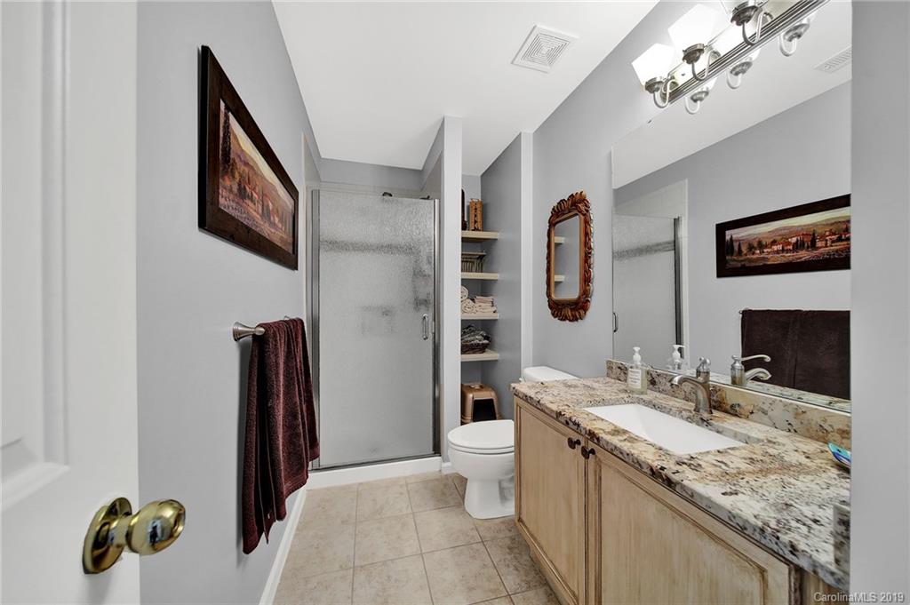 720 Warwick Way Fort Mill, SC 29708 - Photo 24 of 36 a spacious bathroom with a granite countertop sink and a mirror