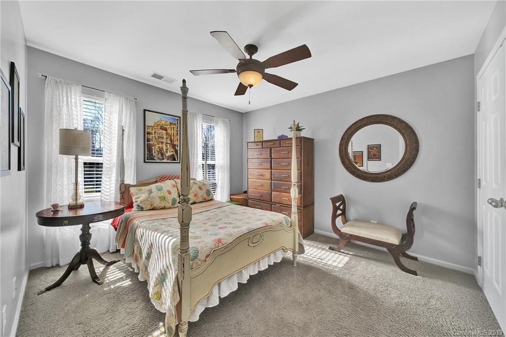 720 Warwick Way Fort Mill, SC 29708 - Photo 25 of 36 a bedroom with a bed a window and a chandelier