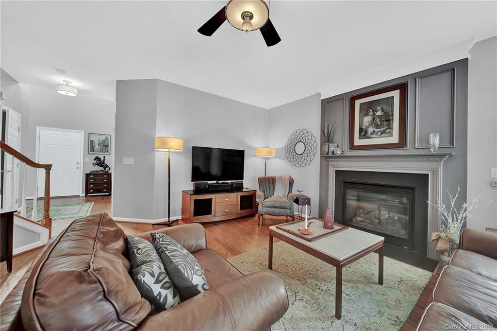 720 Warwick Way Fort Mill, SC 29708 - Photo 7 of 36 a living room with furniture ceiling fan and a fireplace