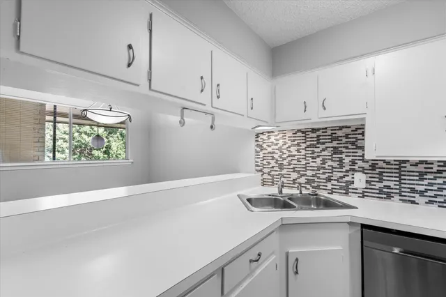 a kitchen with a sink and cabinets