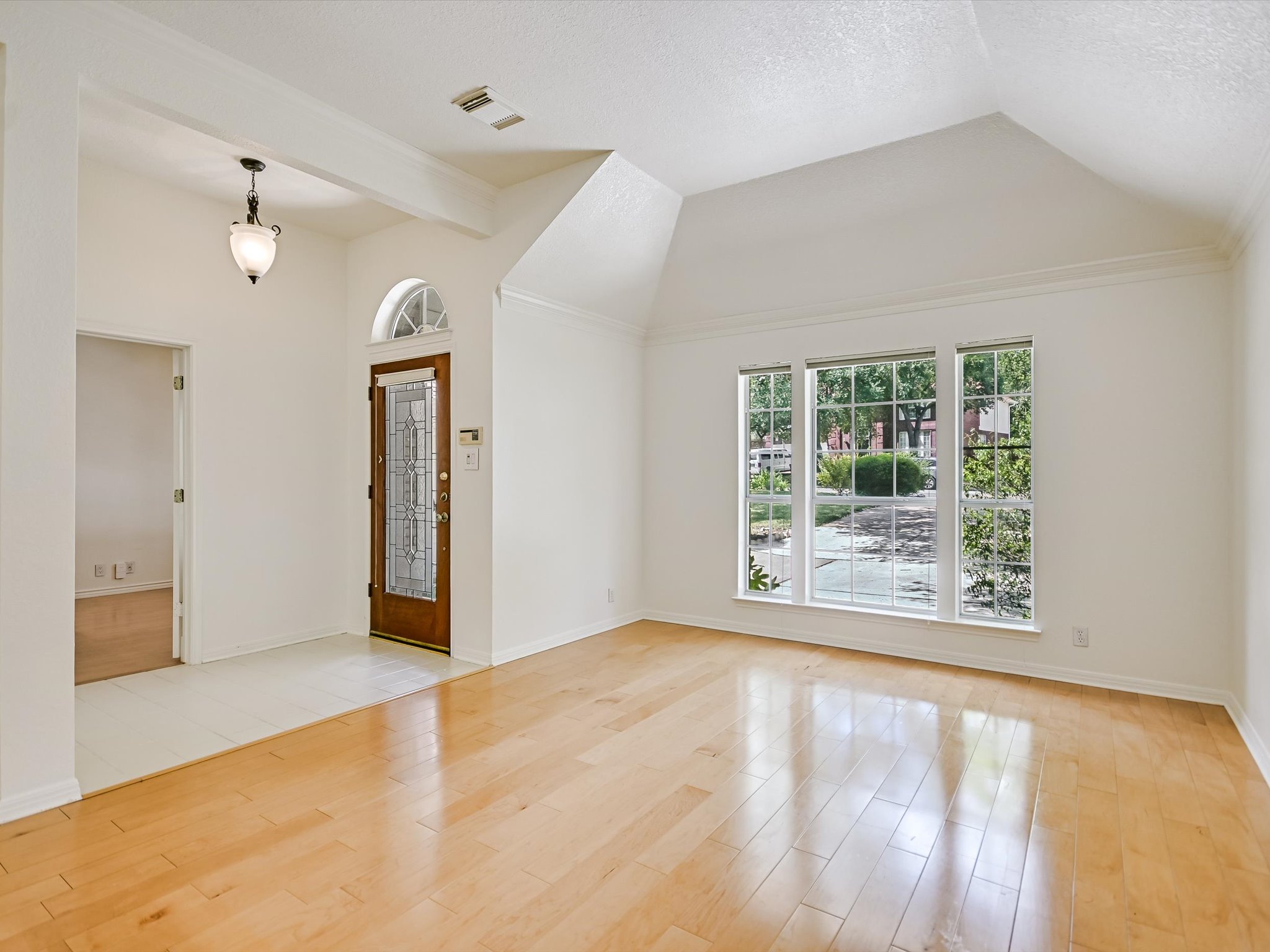 10817 Redmond Road Austin, TX 78739 - Photo 6 of 21 Inside the entry foyer opens to an open concept formal living and dining area under soaring ceilings with a gorgeous front facing picture window.