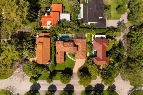 an aerial view of residential houses with outdoor space and street view
