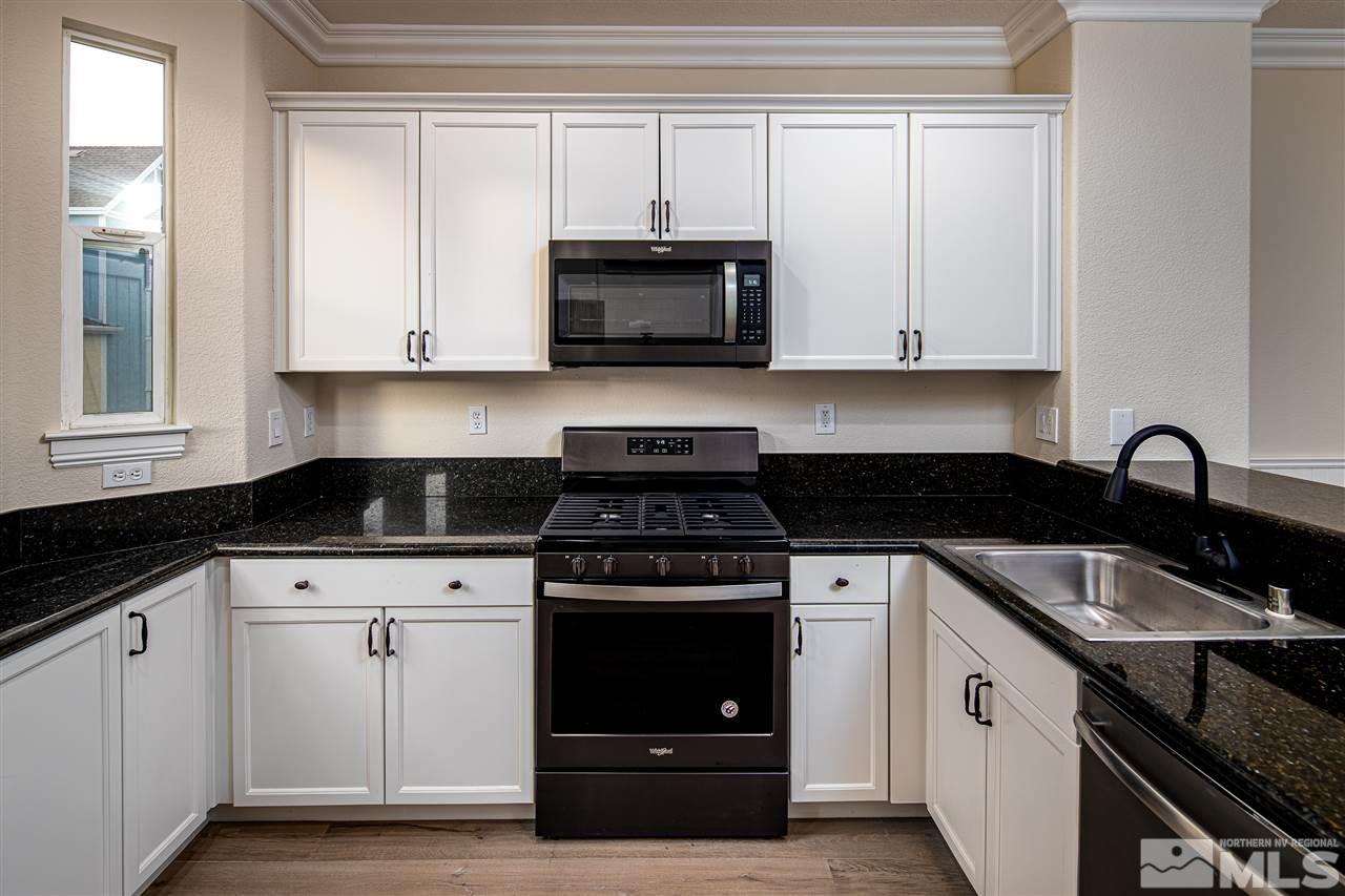 260 Gramercy Lane Reno, NV 89509 - Photo 6 of 25 a kitchen with white cabinets and appliances