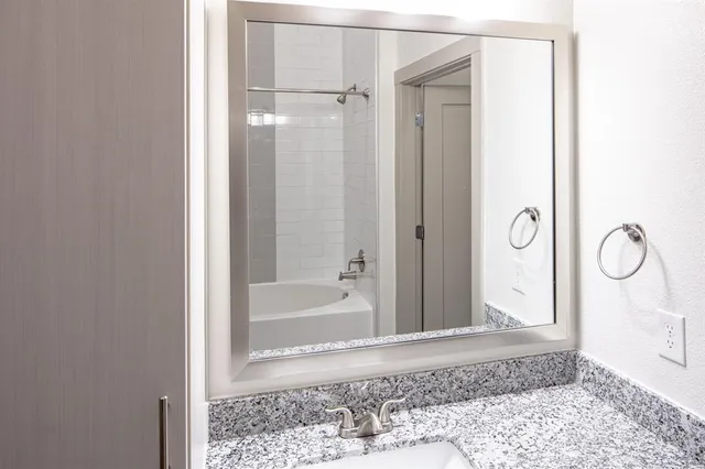 a bathroom with a glass shower door