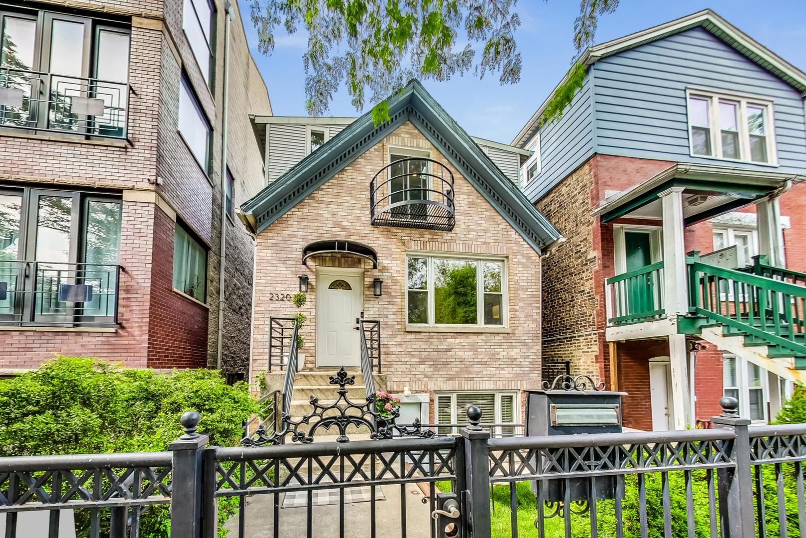 2320 West Belden Avenue Chicago, IL 60647 - Photo 1 of 36 a front view of a house with a garden