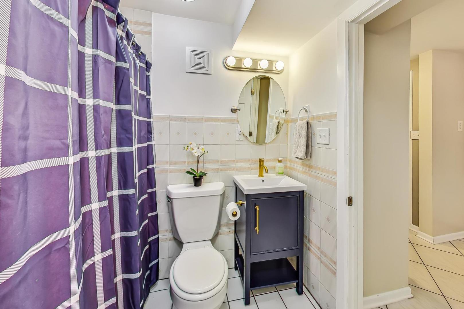 2320 West Belden Avenue Chicago, IL 60647 - Photo 24 of 36 a white toilet sitting next to a bathroom sink