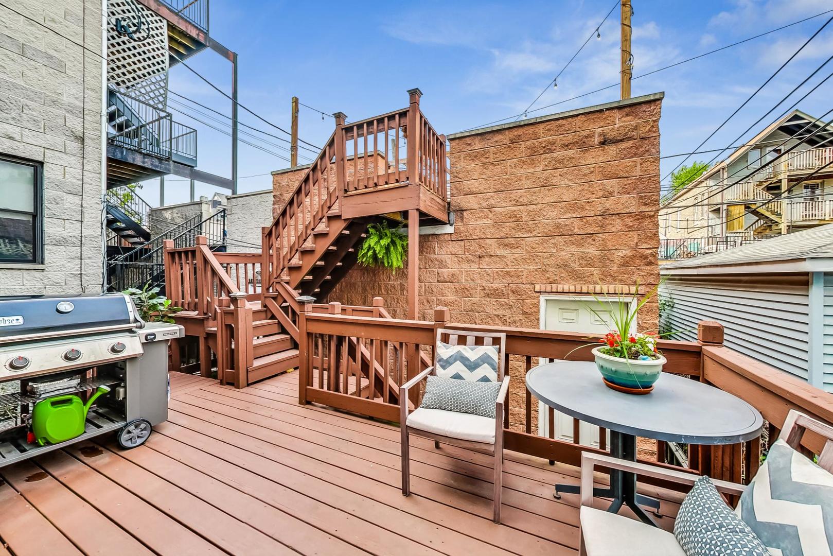 2320 West Belden Avenue Chicago, IL 60647 - Photo 25 of 36 a roof deck view with table and chairs