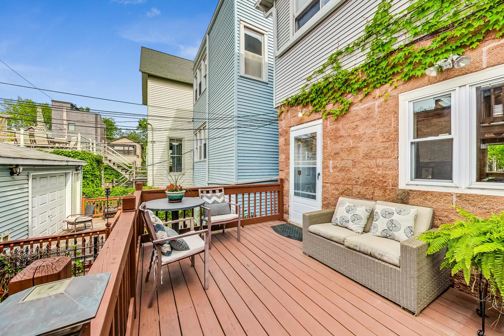 2320 West Belden Avenue Chicago, IL 60647 - Photo 26 of 36 a balcony with furniture and wooden floor