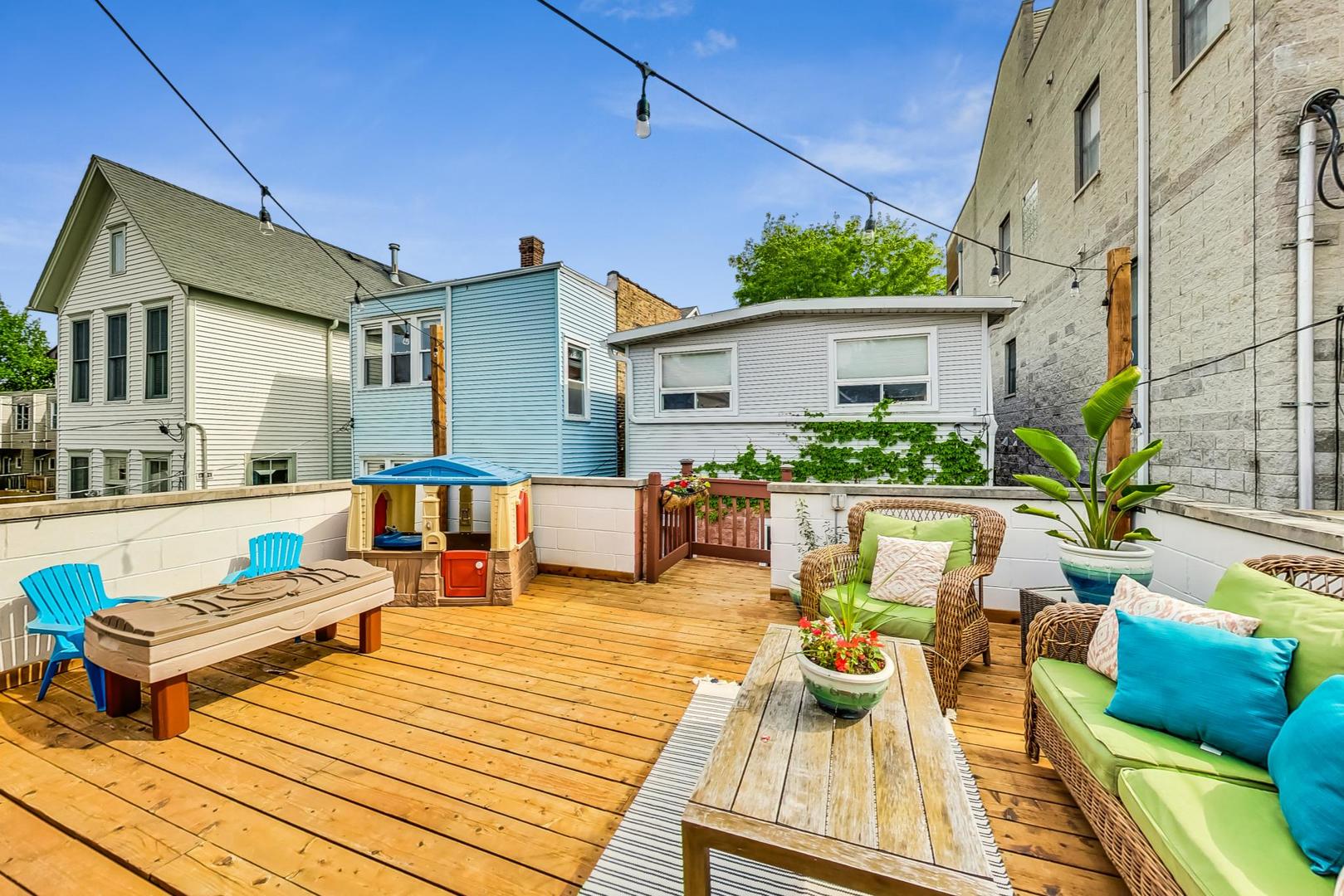 2320 West Belden Avenue Chicago, IL 60647 - Photo 28 of 36 a view of a patio with couches table and chairs with wooden floor