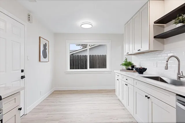 a kitchen with a sink cabinets and window