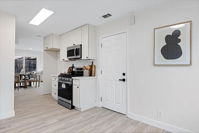 a kitchen with a refrigerator and a stove