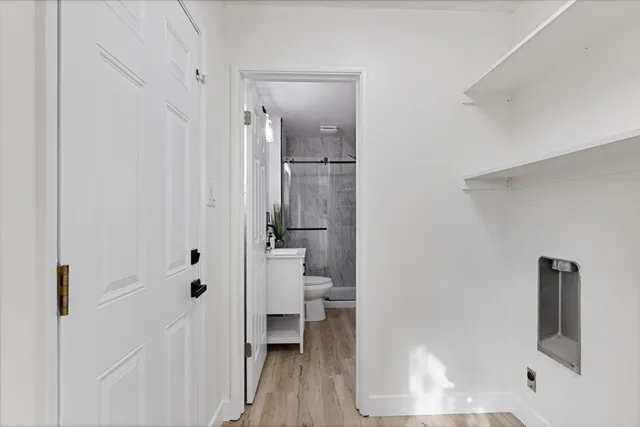 a bathroom with a toilet and a shower
