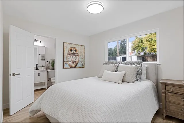 a bedroom with a large bed and a large window