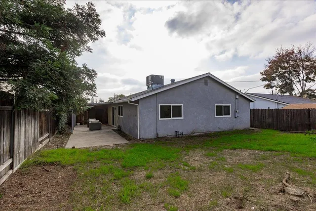 a front view of house with backyard and green space