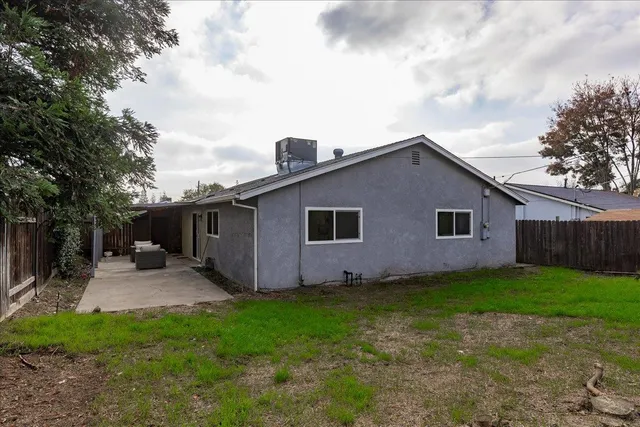 a backyard of a house with yard and barbeque oven