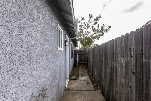 a view of a pathway of a wooden fence