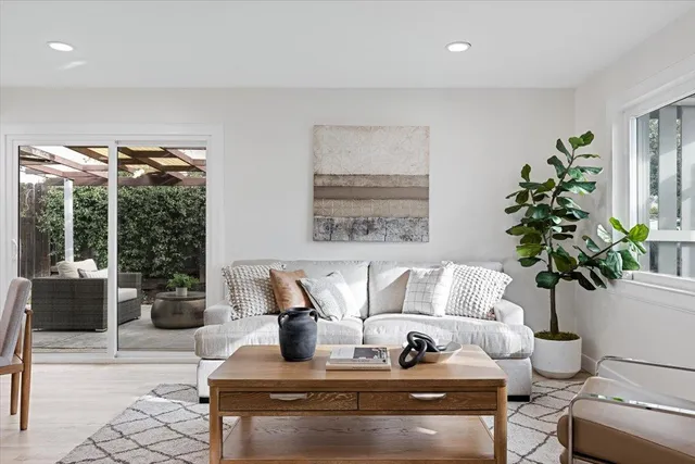 a living room with furniture and potted plants