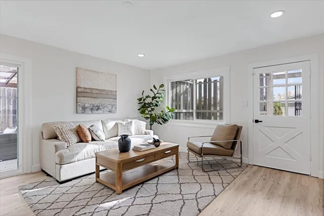 a living room with furniture and wooden floor