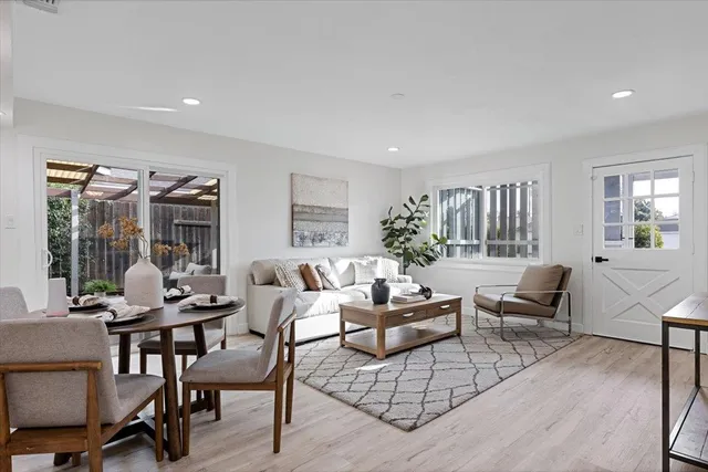 a living room with furniture and wooden floor