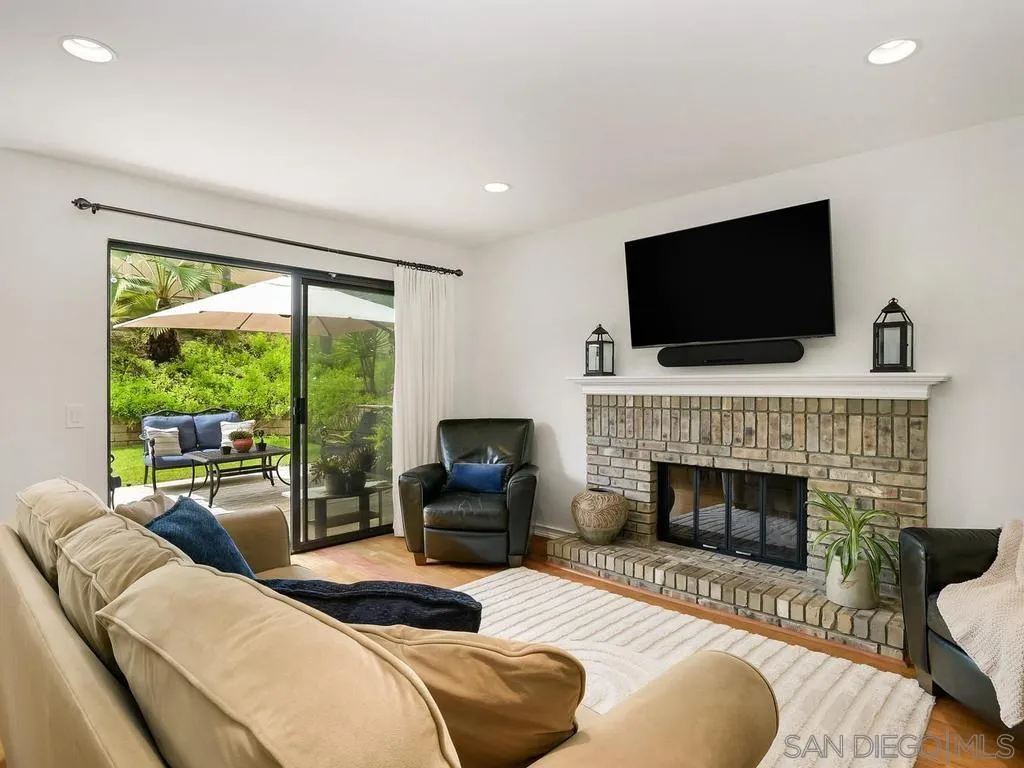 1981 Avenida Joaquin Encinitas, CA 92024 - Photo 20 of 51 a living room with furniture a fireplace and a flat screen tv