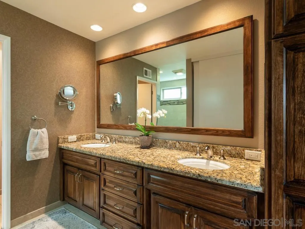 1981 Avenida Joaquin Encinitas, CA 92024 - Photo 27 of 51 a bathroom with a granite countertop double vanity sink and a mirror