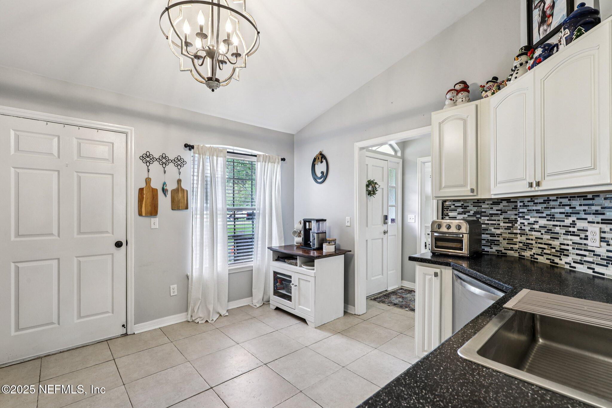 8053 Queensferry Lane Jacksonville, FL 32244 - Photo 16 of 45 a kitchen with a refrigerator and cabinets